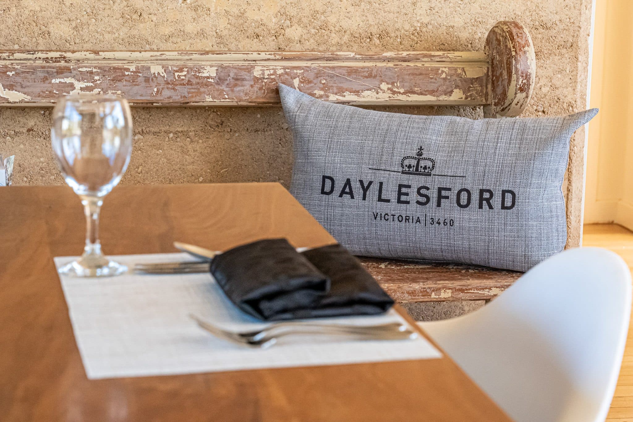 Daylesford cushion and glassware on the table